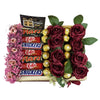 Gift basket with flowers and candy bars including KitKat, Mars, and Snickers on a white background.