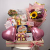 Gift basket with flowers, balloons, and snacks on a gray background