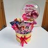 Gift basket with flowers, chocolates, and balloons with 'Mama A Title Above Queen' message.
