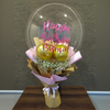 Bouquet with a transparent sphere displaying 'Happy Birthday Bisma' on a wooden surface.