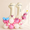 Number 11 birthday balloon with pink and white balloons and butterflies on a beige background